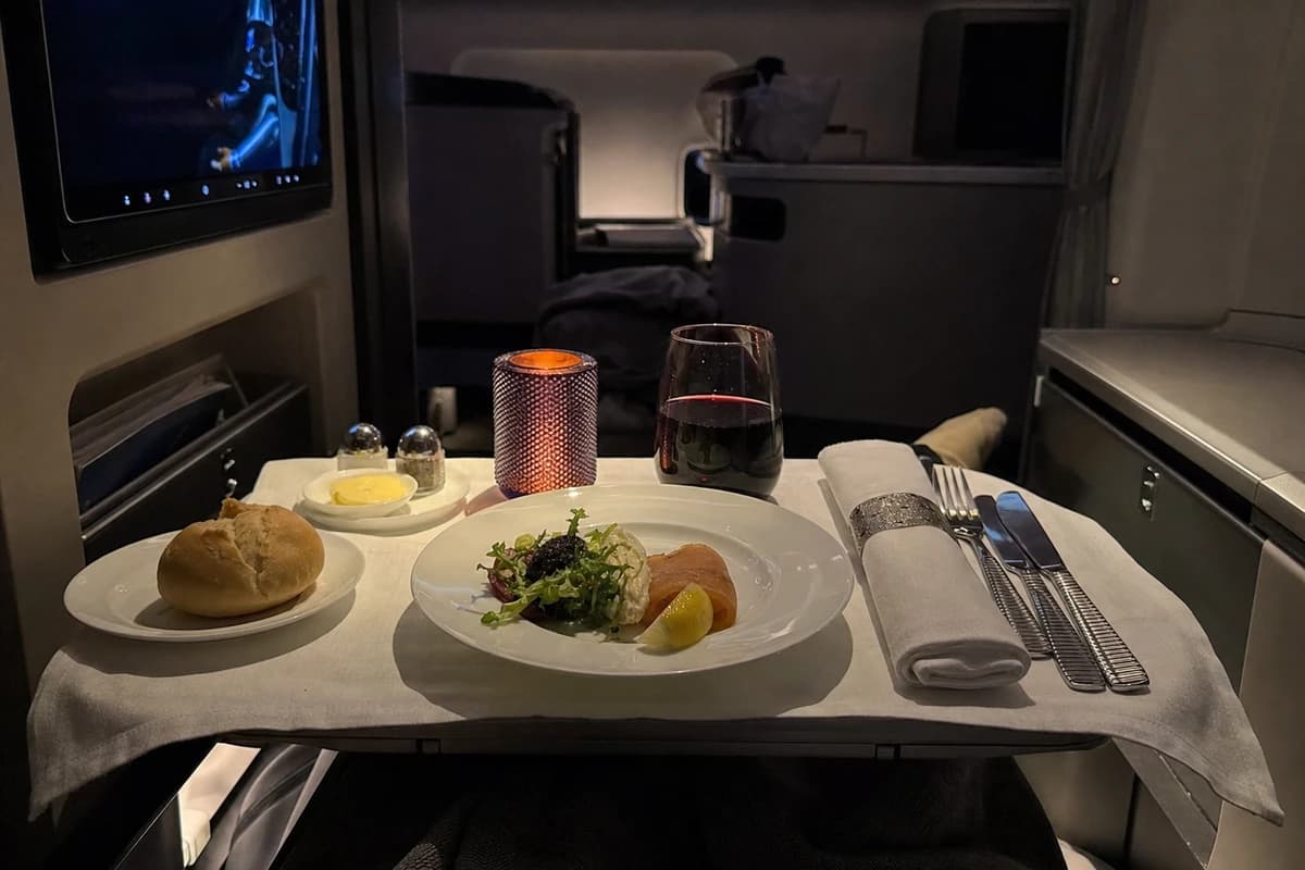 A proper multicourse dinner at 38,000 feet — one of the tangible differences that justify paying for business class