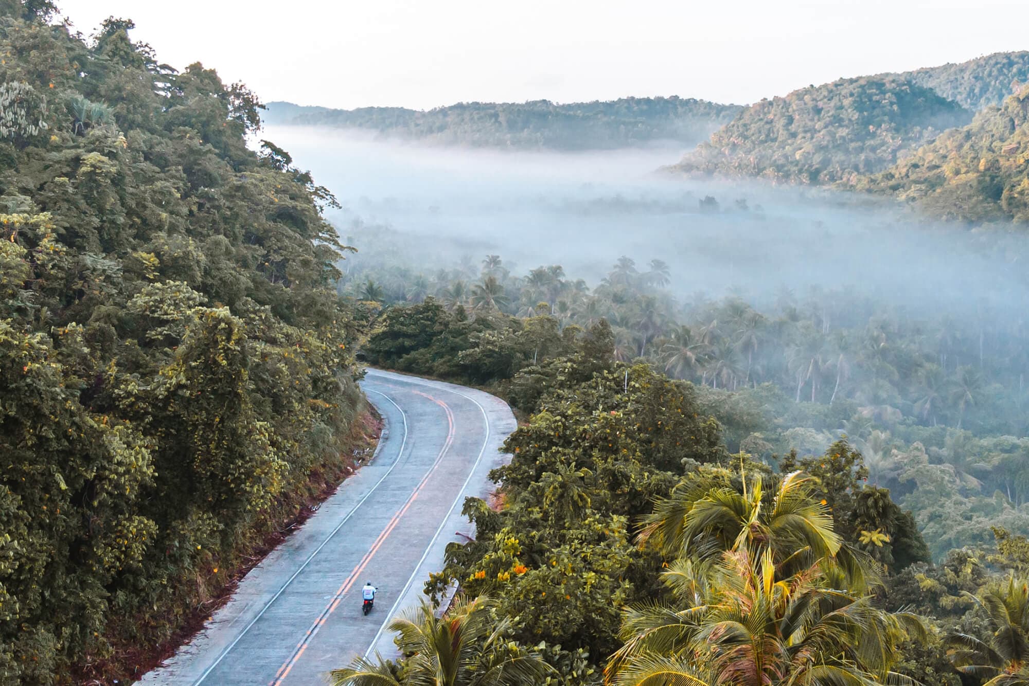Riding a motorbike on the roads of Siargao island, Philippines. Photo by Alejandro Luengo.