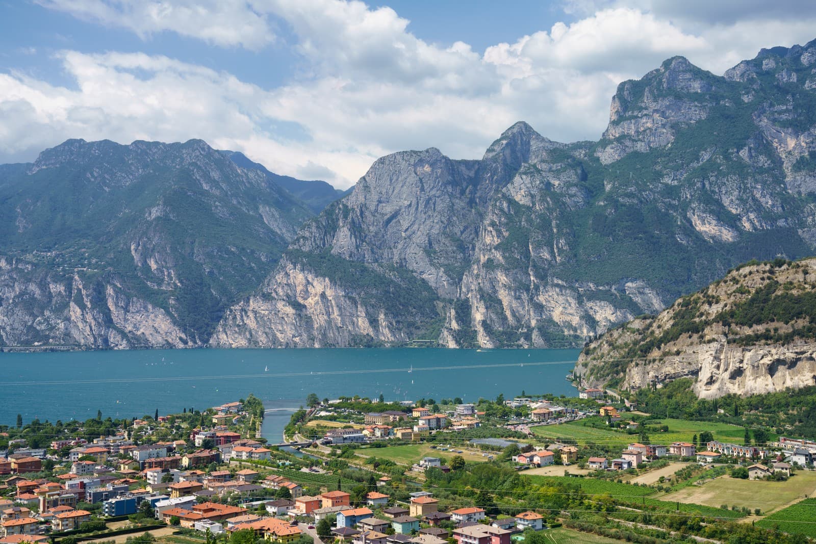 The charming town of Torbole sits at the northern shore of Lake Garda, surrounded by dramatic cliffs and lush mountains, offering a breathtaking view of Italy’s largest lake.