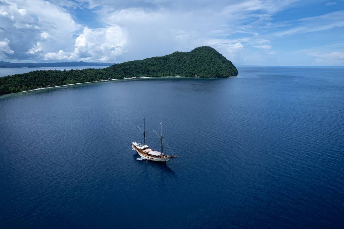 Liveaboard diving ship anchored near Kri Island in Raja Ampat.