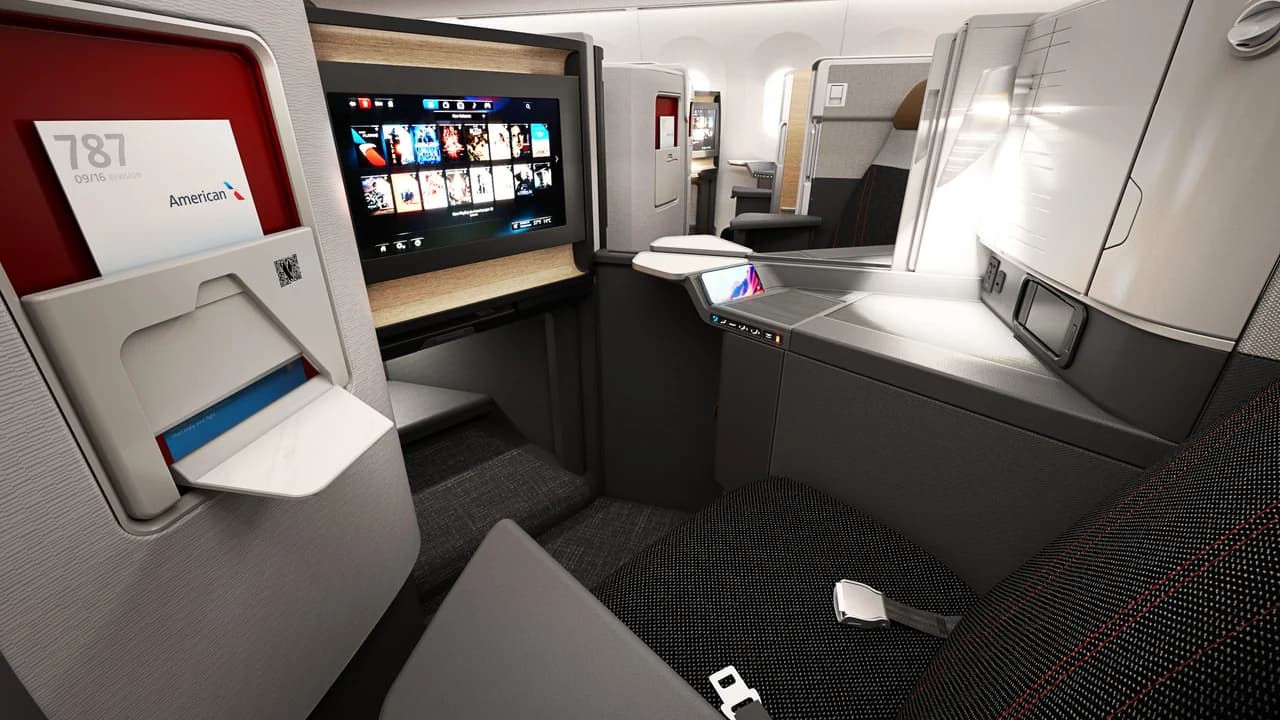 American Airlines Flagship Suite with Adient Ascent platform — enclosed suite with privacy door and 4K entertainment screen