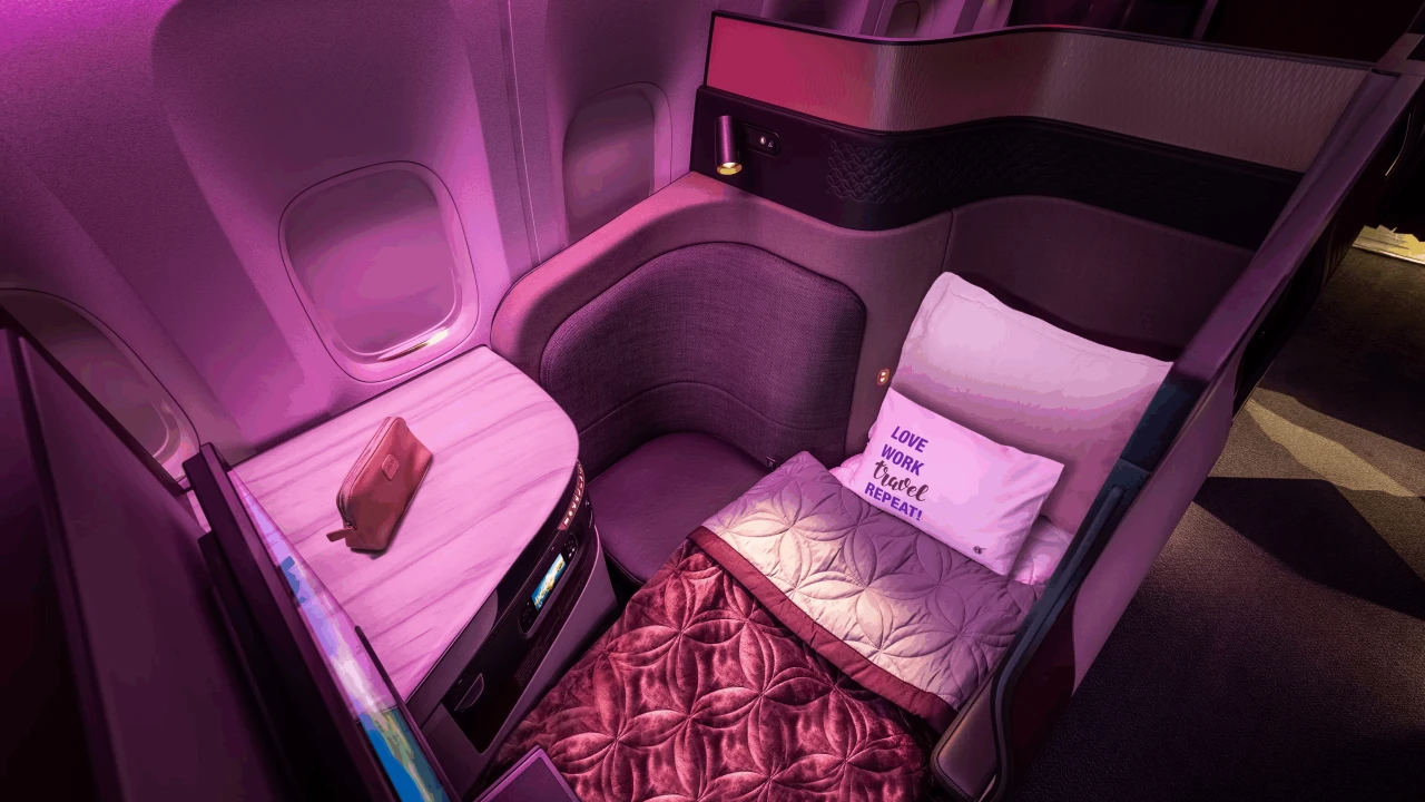 The Qsuite seat features ample storage for amenity kits and personal items during flight.